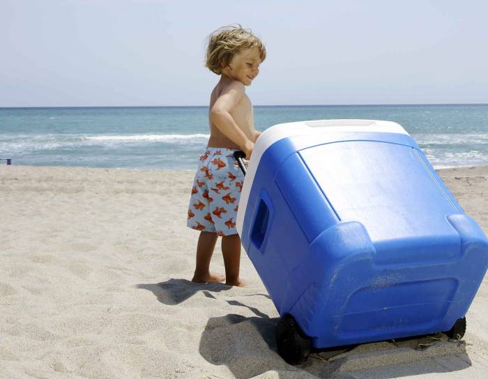 little kid pulling a rolling cooler