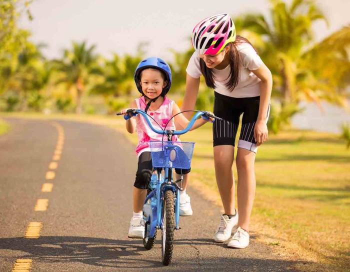 Child learning how to ride a bicycle