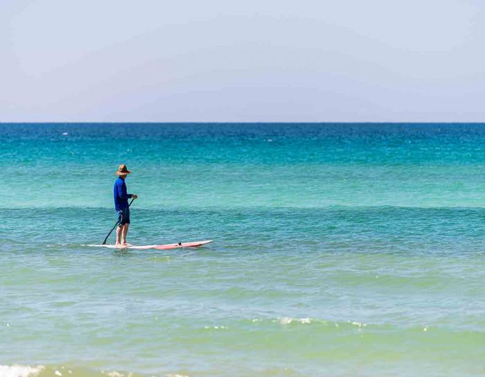 Man in the water with a paddle board